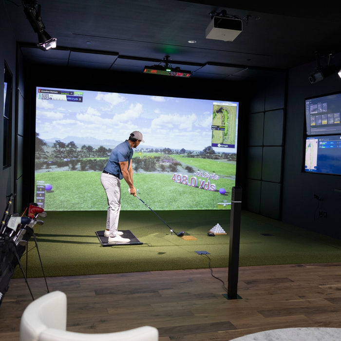 Golfer swinging in a simulator with the Uneekor EYE XO2 mounted overhead