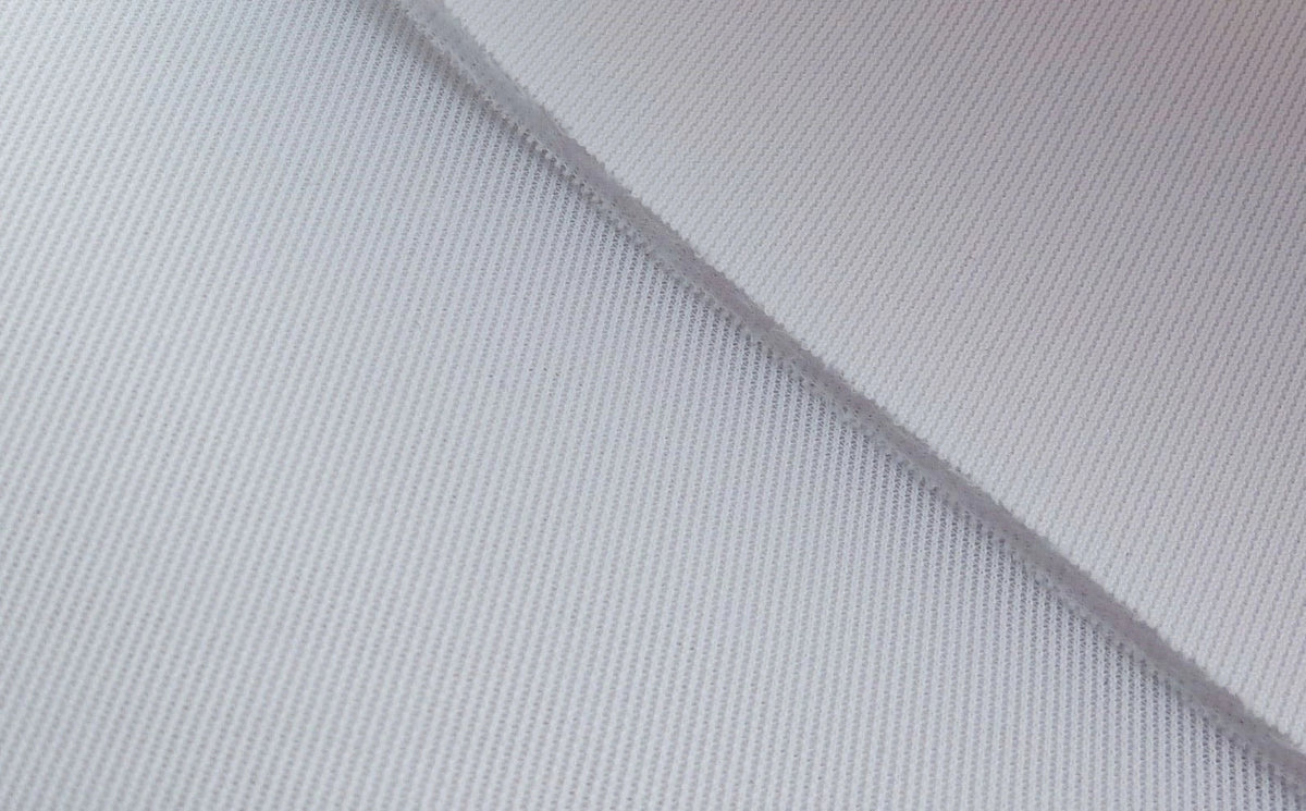 Close up of Carl’s premium woven polyester golf impact screen fabric with a diagonal fold showing its texture