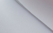 Close up of Carl’s premium woven polyester golf impact screen fabric with a diagonal fold showing its texture