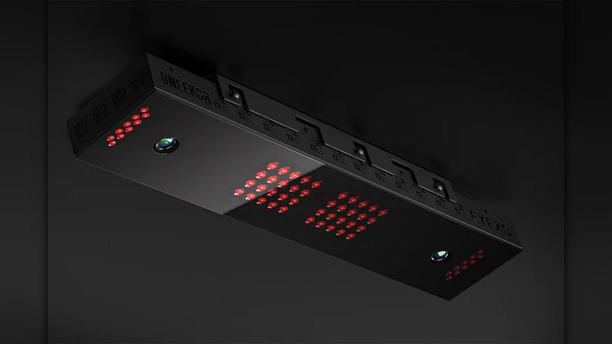 Underside view of the Uneekor Eye XO launch monitor showing dual cameras and infrared sensor arrays