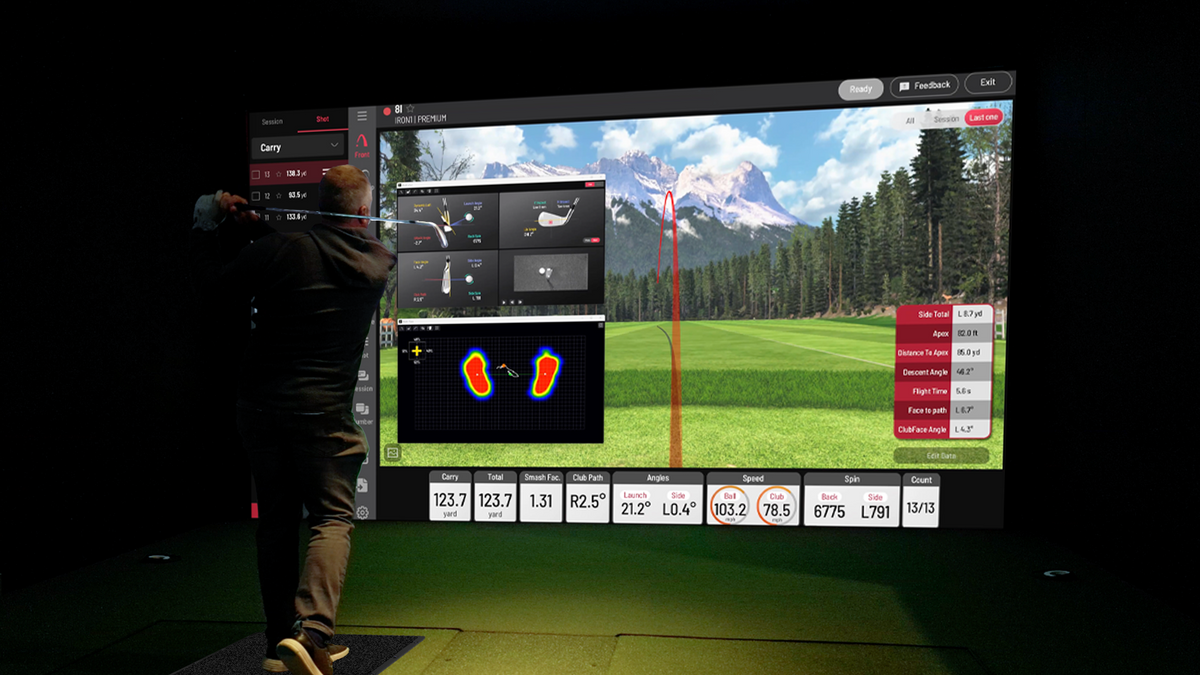 Golfer swinging in a residential simulator room with Uneekor Eye XO2 and Balance Optix mat, showing shot data and weight distribution