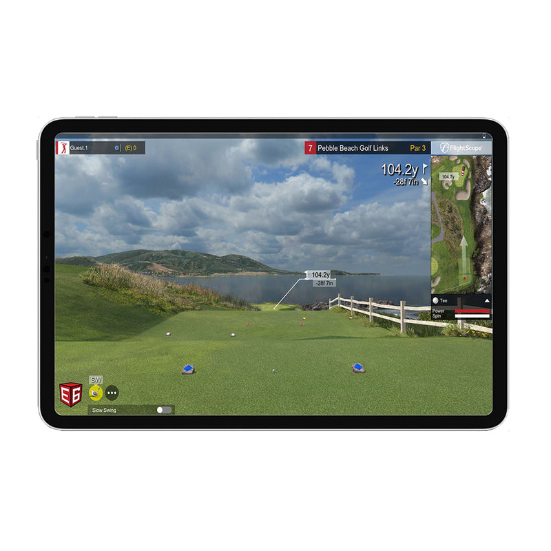 Mevo+ tablet displaying a golf simulation app with a scenic golf course view.