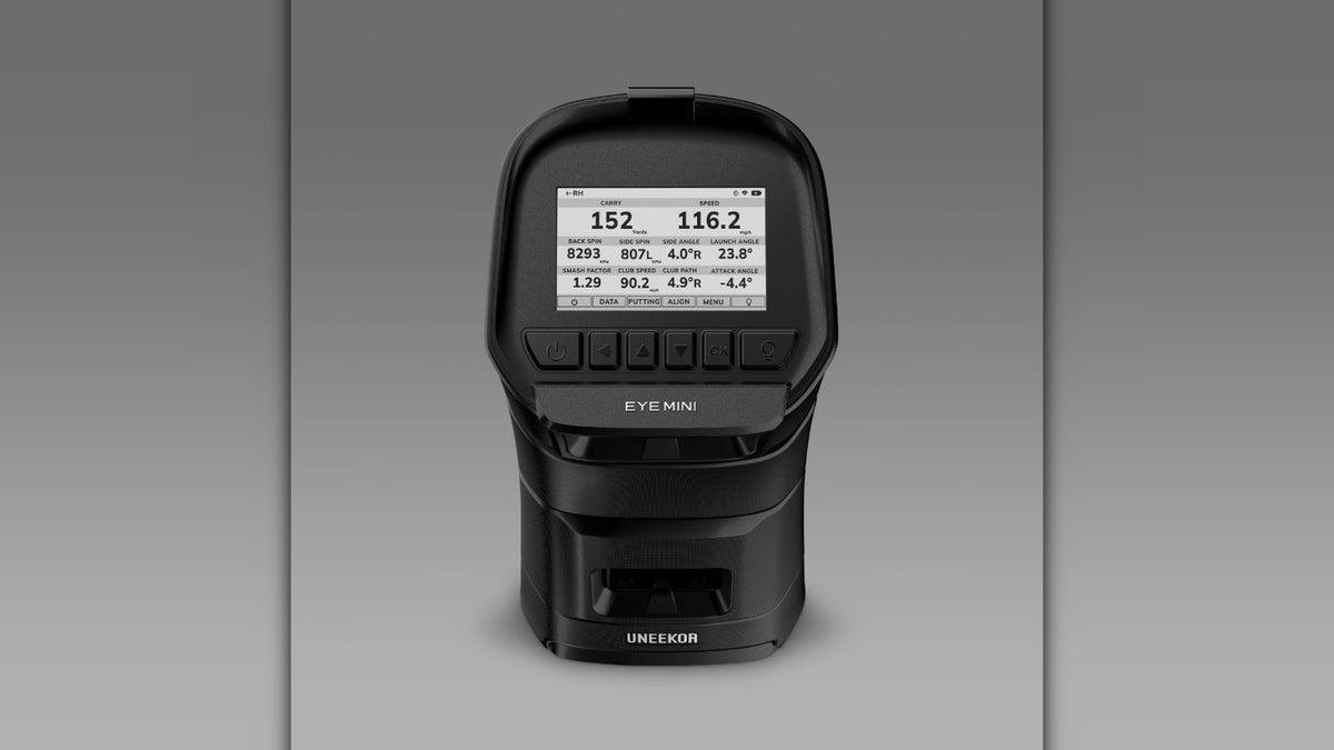 Close up front view of the Uneekor Eye Mini launch monitor showing the control buttons and on screen shot data readout