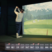 Golfer swinging in a Uneekor Eye XR golf simulator with mountain course on screen and live shot data displayed