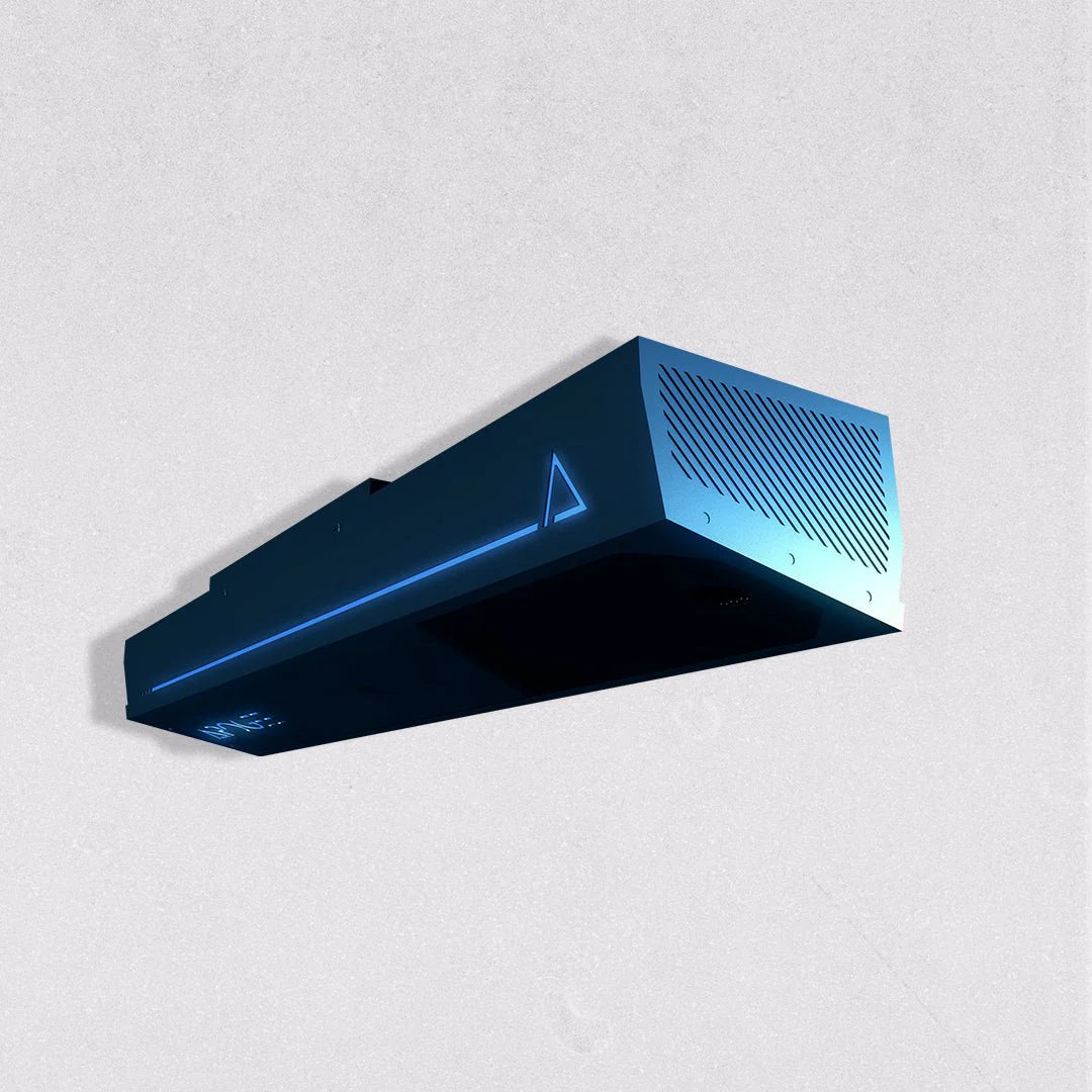 TruGolf APOGEE launch monitor unit shown at an angle, a dark rectangular device with vent slats and a glowing blue triangle logo, on a light gray background
