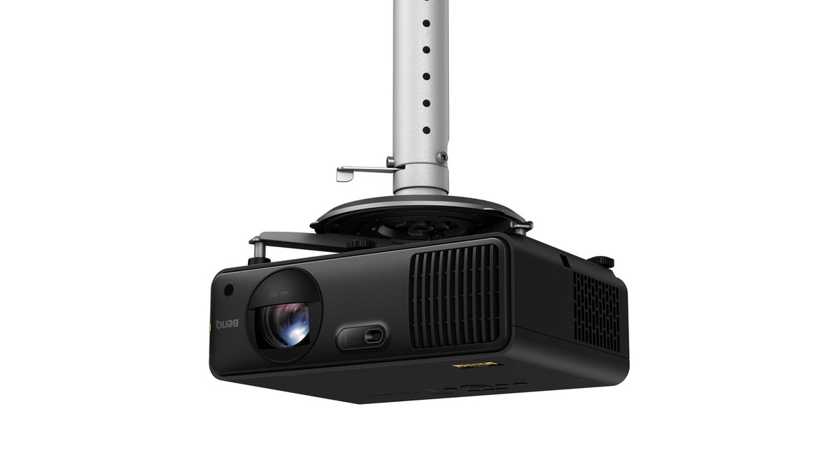 BenQ AK700ST projector mounted upside down on a ceiling mount pole, showing the lens and vents in an installed configuration