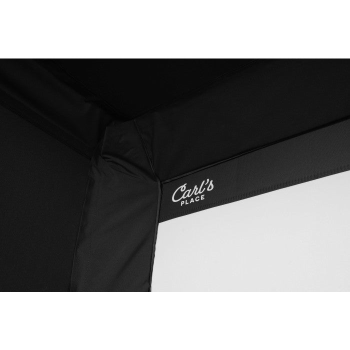 Close up of the corner seam on Carl’s Pro Golf Simulator Enclosure Kit showing the Carl’s Place logo stitched on the black fabric surround